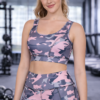 Woman wearing pink black camo sports bra with removable cups during gym workout lifestyle shot