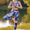 High waist gym pants with mobile pocket for women in blue camo during yoga balance pose