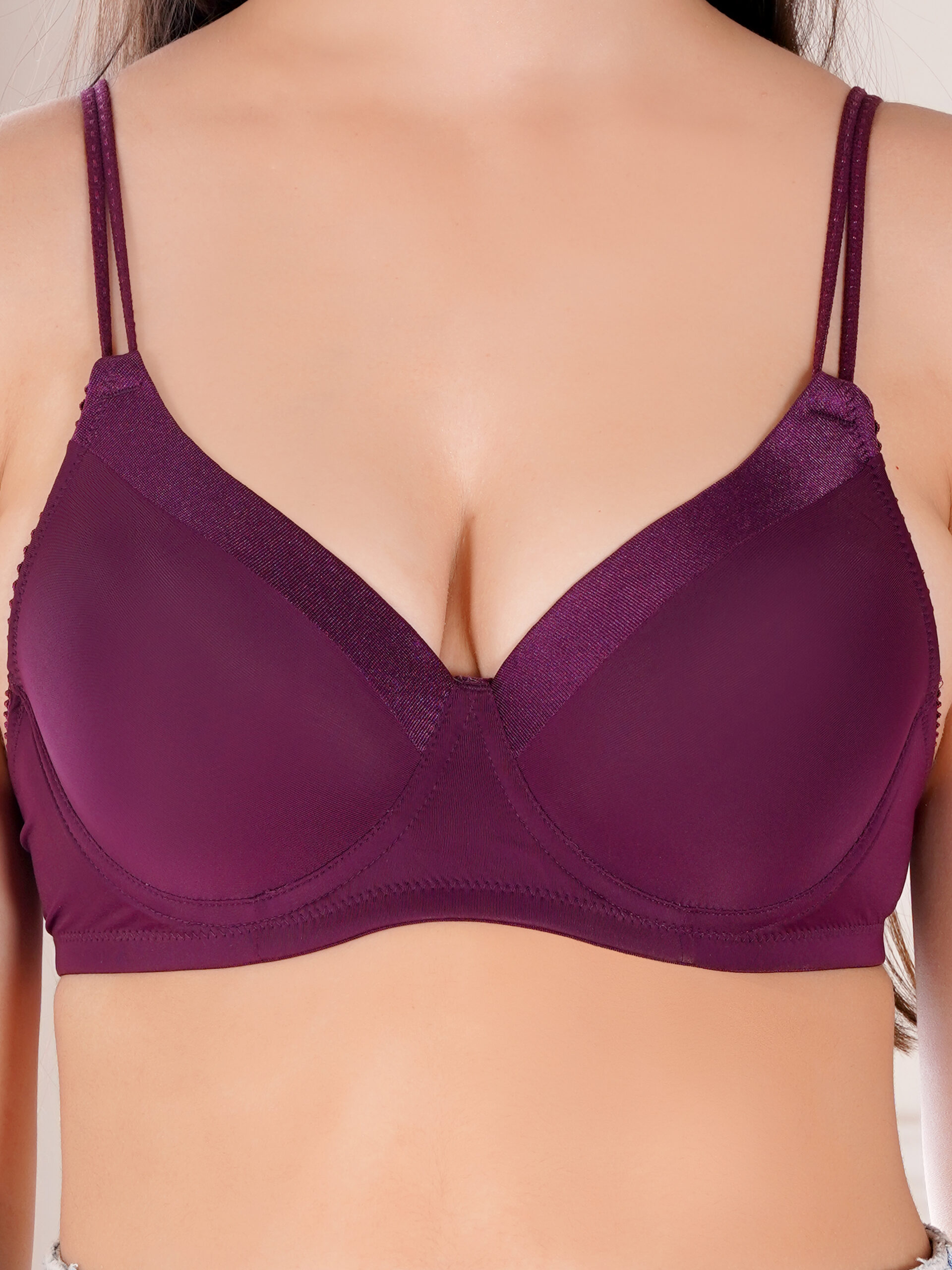 Close up of satin edges and dori style straps on underwired push up bra